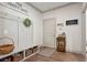Mudroom featuring a built-in bench with storage, coat hooks, and hardwood floors at 110 White Oak Trl, Cumming, GA 30028