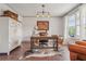 Cozy home office with natural light, hardwood floors, and built-in cabinets for storage at 110 White Oak Trl, Cumming, GA 30028