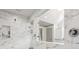 Elegant walk-in shower featuring marble tiling, dual shower heads, and glass door at 110 White Oak Trl, Cumming, GA 30028