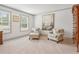 Cozy sitting area in bedroom with neutral decor, art and natural light at 110 White Oak Trl, Cumming, GA 30028