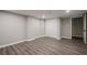 Basement features wood-look flooring and neutral paint, with a large closet for storage and access to other rooms at 1331 Windage Sw Ct, Marietta, GA 30008