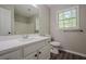 Bathroom featuring modern vanity, granite countertop, and window providing natural light for getting ready at 1331 Windage Sw Ct, Marietta, GA 30008