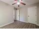 Bedroom features wood-look flooring and neutral paint, leading to a hallway with storage space at 1331 Windage Sw Ct, Marietta, GA 30008