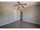 Bedroom features wood-look flooring and neutral paint, leading to a hallway with storage and natural light at 1331 Windage Sw Ct, Marietta, GA 30008