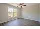 Bedroom features wood-look flooring and neutral paint, and a large window overlooking a wooded view at 1331 Windage Sw Ct, Marietta, GA 30008