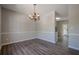 Elegant dining room featuring stylish flooring, a modern chandelier, and neutral wall paint at 1331 Windage Sw Ct, Marietta, GA 30008