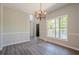 Bright dining area featuring a modern chandelier, natural light from a large window, and neutral decor at 1331 Windage Sw Ct, Marietta, GA 30008