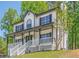 Beautiful two-story home showcasing a lovely front porch and lush green surroundings at 1331 Windage Sw Ct, Marietta, GA 30008