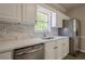 Bright kitchen showcasing stainless steel appliances, white cabinets, and modern countertops at 1331 Windage Sw Ct, Marietta, GA 30008