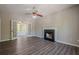 Spacious living room with a cozy fireplace, ceiling fan, and French doors leading to a sunroom at 1331 Windage Sw Ct, Marietta, GA 30008