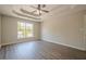 Large main bedroom featuring decorative ceilings, wood look floors, and a large bright window at 1331 Windage Sw Ct, Marietta, GA 30008