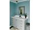 Chic bathroom displays a vanity with ample storage, a mirror, and modern lighting at 153 Helen Rd, Covington, GA 30016