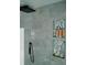 Modern bathroom showcases tiled walls and recessed shelving for toiletries, blending style and functionality at 153 Helen Rd, Covington, GA 30016