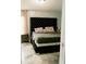 Comfortable bedroom boasts a plush, cushioned headboard and neutral décor, providing a relaxing retreat at 153 Helen Rd, Covington, GA 30016
