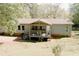Charming home featuring a covered porch, complemented by the lush, green surroundings at 153 Helen Rd, Covington, GA 30016