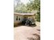 Side view of the home featuring a covered porch with gray railings and a gravel driveway at 153 Helen Rd, Covington, GA 30016