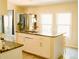 Bright kitchen with a central island featuring granite countertops, storage cabinets, and a sink at 153 Helen Rd, Covington, GA 30016