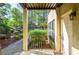 Exterior entry of condo unit with covered entrance, outdoor lighting, and green view at 407 Coleraine Se, Smyrna, GA 30080