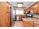 Cozy kitchen featuring wood cabinets, stainless steel appliances, and granite countertops at 407 Coleraine Se, Smyrna, GA 30080