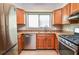 Close-up of updated kitchen, featuring stainless steel appliances and light wood cabinets at 407 Coleraine Se, Smyrna, GA 30080