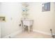 Bright laundry room featuring a sink, storage shelves, and tile flooring at 407 Coleraine Se, Smyrna, GA 30080