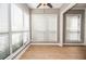 Sunlit living room featuring three large windows and ceiling fan at 407 Coleraine Se, Smyrna, GA 30080