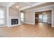Bright living room with fireplace, wood floors, white trim, and view of dining area at 407 Coleraine Se, Smyrna, GA 30080
