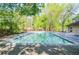 Large rectangular pool with an expansive deck and serene tree-lined surroundings at 407 Coleraine Se, Smyrna, GA 30080