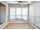 Bright, sunny sunroom with wood floor, large windows, and white window blinds at 407 Coleraine Se, Smyrna, GA 30080