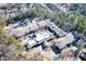 Aerial view of the community, showcasing its layout, surrounded by trees and parking areas at 475 Mount Vernon Ne Hwy # C-220, Sandy Springs, GA 30328