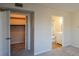 Open bedroom with a closet, connected bath, and neutral carpet, creating a bright and airy space at 475 Mount Vernon Ne Hwy # C-220, Sandy Springs, GA 30328