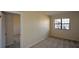 Cozy bedroom featuring neutral carpet, bright natural light from a window, and doorway to another room at 475 Mount Vernon Ne Hwy # C-220, Sandy Springs, GA 30328