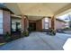 Inviting building entrance with covered area, rocking chairs and landscaping at 475 Mount Vernon Ne Hwy # C-220, Sandy Springs, GA 30328