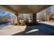 Covered entrance with brick columns, landscaping, and parking for residents and guests at 475 Mount Vernon Ne Hwy # C-220, Sandy Springs, GA 30328