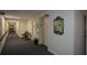 Hallway with elevator, decorative mirror, and comfortable seating area for residents at 475 Mount Vernon Ne Hwy # C-220, Sandy Springs, GA 30328