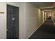 A view down a long hallway leading to a door with visible signage, highlighting accessibility and wayfinding at 475 Mount Vernon Ne Hwy # C-220, Sandy Springs, GA 30328