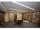 Inviting library featuring bookshelves, a table and chairs, and natural light from the windows at 475 Mount Vernon Ne Hwy # C-220, Sandy Springs, GA 30328