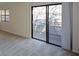 Bright living room with sliding glass door to balcony offering a view, and wall-to-wall neutral carpeting at 475 Mount Vernon Ne Hwy # C-220, Sandy Springs, GA 30328