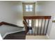 This stairwell features a natural light window and brown bannister highlighting architectural detail at 475 Mount Vernon Ne Hwy # C-220, Sandy Springs, GA 30328