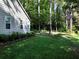 Lush green backyard with healthy lawn and mature trees creating a peaceful natural setting at 1234 W Wylie Bridge Rd, Woodstock, GA 30188