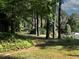 Lush green backyard with healthy lawn and mature trees creating a peaceful natural setting at 1234 W Wylie Bridge Rd, Woodstock, GA 30188