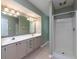 Bright bathroom featuring double sinks, a large mirror, and a walk-in shower at 1234 W Wylie Bridge Rd, Woodstock, GA 30188