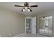 Comfortable bedroom featuring mirrored closet doors, ceiling fan, and natural light at 1234 W Wylie Bridge Rd, Woodstock, GA 30188