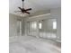 Open bedroom featuring ceiling fan, closet with mirrored doors, and ensuite bath access at 1234 W Wylie Bridge Rd, Woodstock, GA 30188