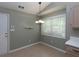Bright dining nook with white trim, wood-look floors, chandelier, and natural light at 1234 W Wylie Bridge Rd, Woodstock, GA 30188