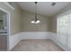 Empty dining room with window and chandelier at 1234 W Wylie Bridge Rd, Woodstock, GA 30188