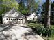 View of home with a driveway and mature trees at 1234 W Wylie Bridge Rd, Woodstock, GA 30188
