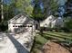 Charming single-story home featuring a two-car garage, well-manicured lawn, and mature trees providing ample shade at 1234 W Wylie Bridge Rd, Woodstock, GA 30188