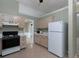 Charming kitchen features traditional cabinetry, modern appliances, and hardwood style flooring at 1234 W Wylie Bridge Rd, Woodstock, GA 30188