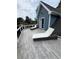 Back porch featuring new deck boards, blue siding, and patio furniture at 3147 Pine Needle Sw Ct, Lilburn, GA 30047